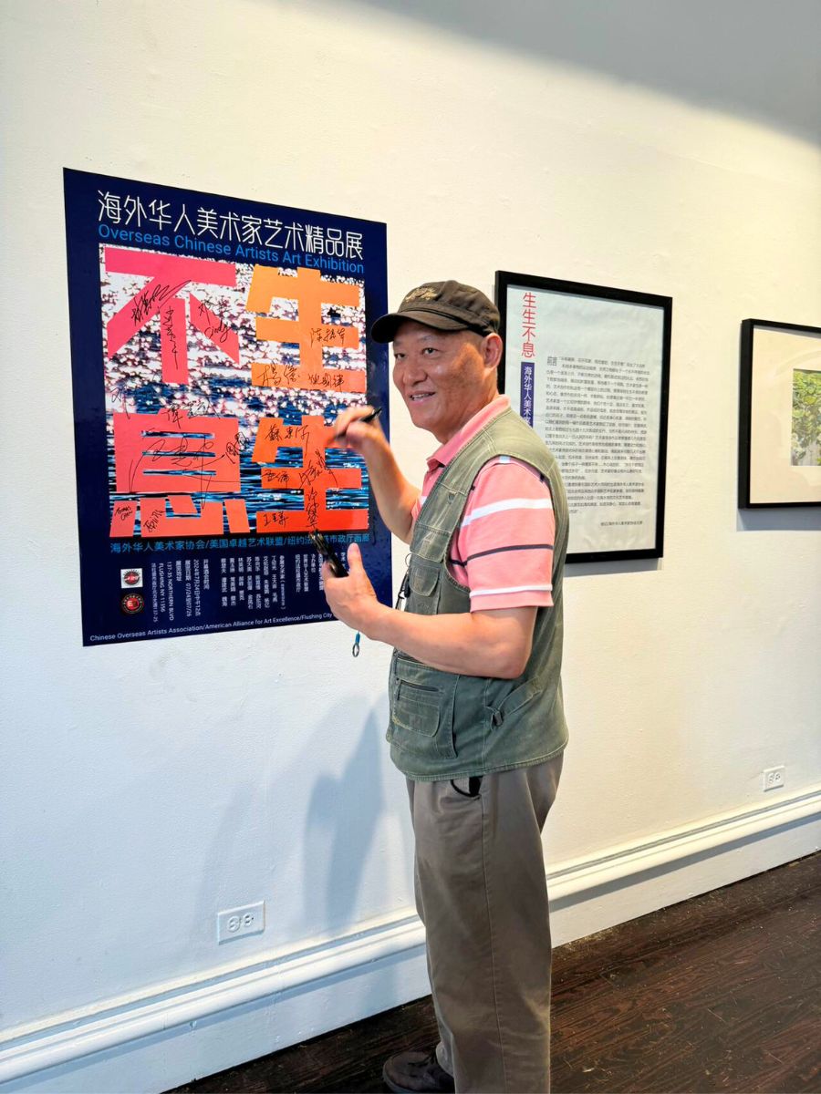 Steven zhou pointing at painting in gallery